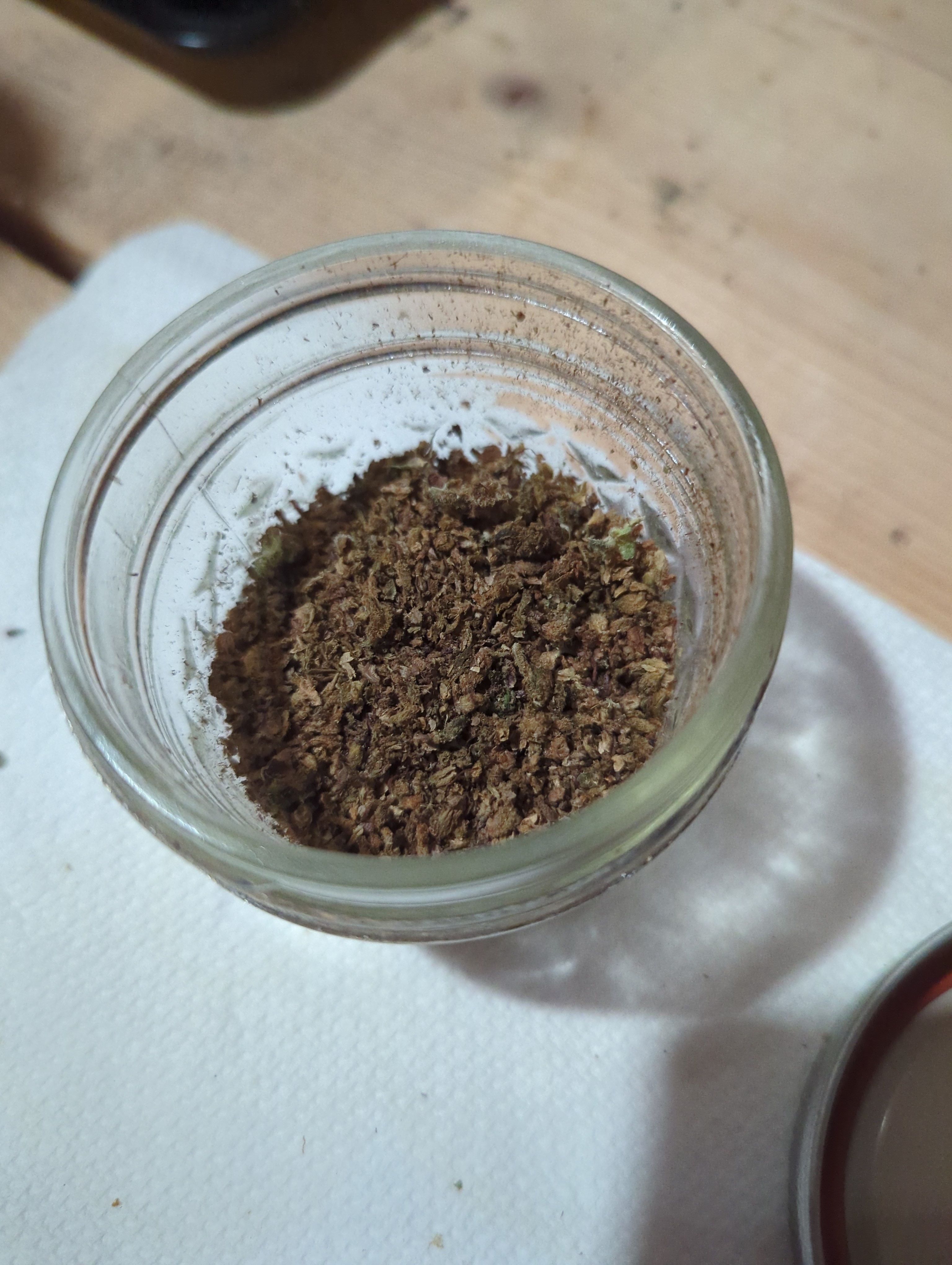 top down view of same jar. the bud in it ranges in shades from brown to green